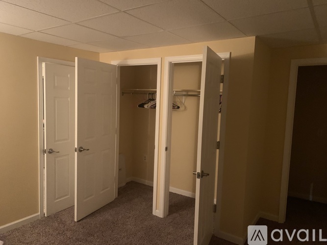 A room with three open closets.