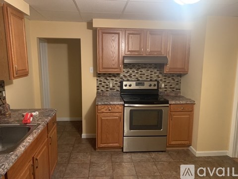 A kitchen with wooden cabinets and a granite countertop.