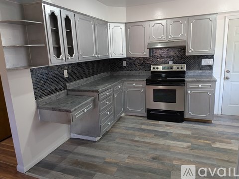 A kitchen with a stove and cabinets.