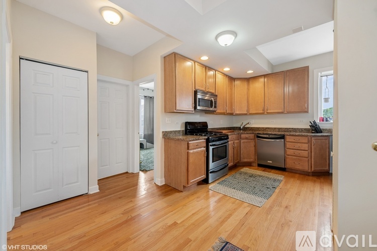 A kitchen with wooden cabinets and a central island.