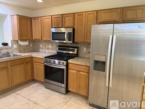 A kitchen with wooden cabinets and stainless steel appliances.