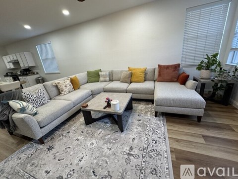 A living room with a grey sofa and a coffee table.