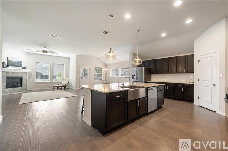 A modern kitchen with dark wood cabinets and a central island.