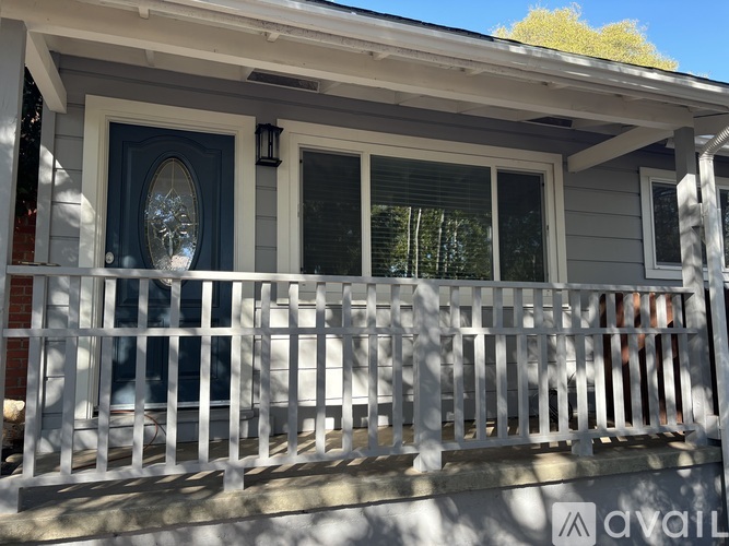 A house with a blue door and white railings.