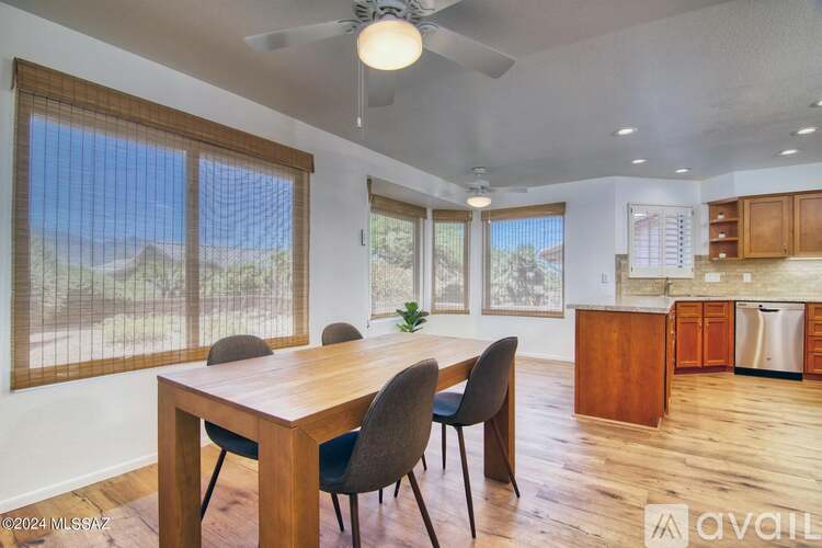 A dining room with a wooden table and chairs.