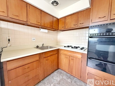 A kitchen with wooden cabinets and a white countertop.
