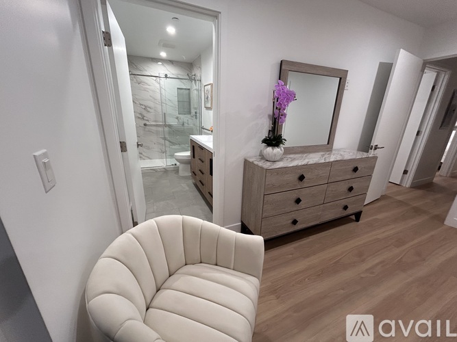 A bathroom with a marble countertop and a white chair.