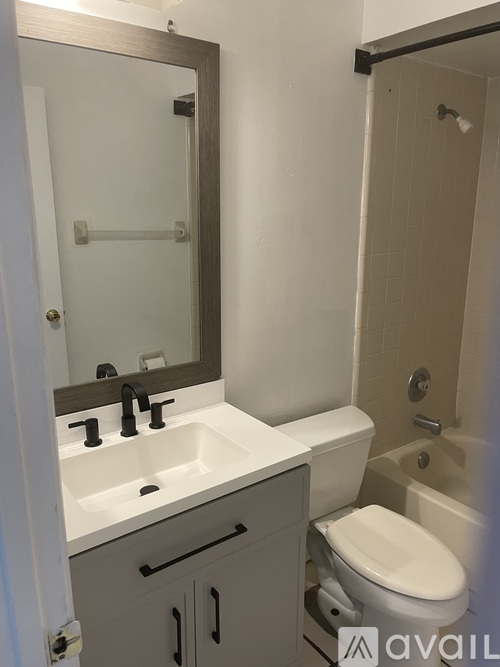 A bathroom with a sink, toilet and bathtub.