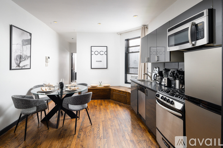 A kitchen with a dining table and chairs in the middle of the room.