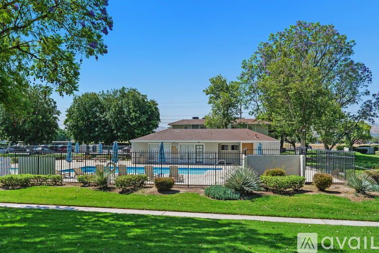 A house with a pool in the backyard surrounded by greenery.