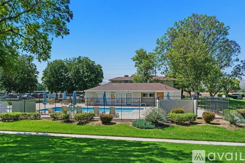 A house with a pool in the backyard surrounded by greenery.