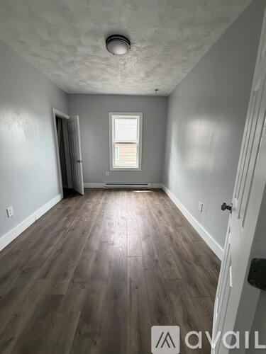 A room with wooden floors and a window.