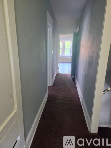 A long hallway with a door at the end.
