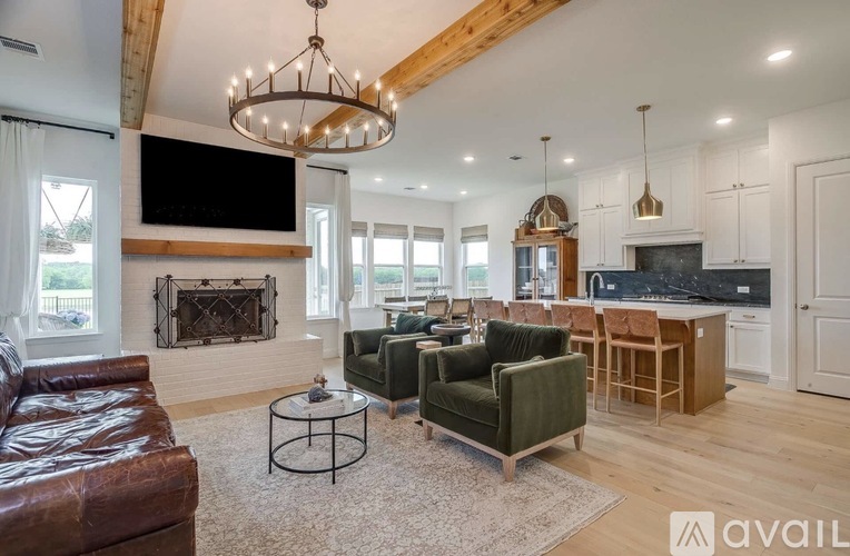 A living room with a brown leather couch, a green armchair, and a coffee table.