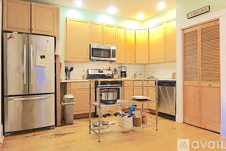A kitchen with wooden cabinets and a refrigerator.