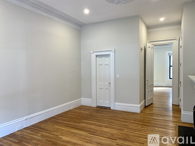 A room with wooden floors and white walls.