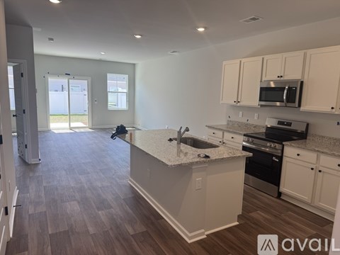 A kitchen with a countertop and cabinets is available for rent.