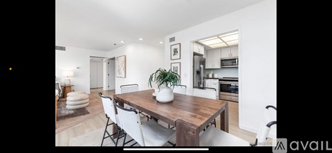A modern kitchen with a dining table and chairs.