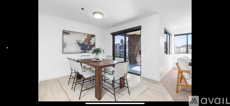 A dining room with a wooden table and chairs.