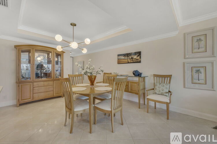 A dining room with a wooden table and chairs.