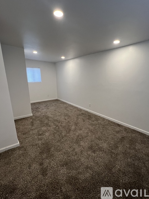 A room with carpeted floor and white walls.