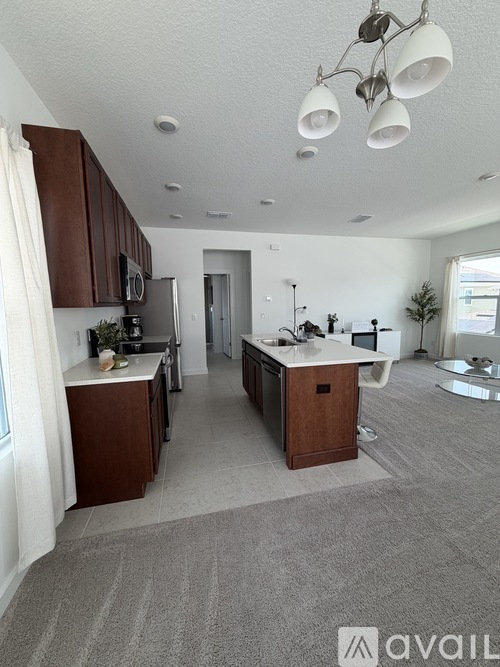 A kitchen with brown cabinets and a white fridge.