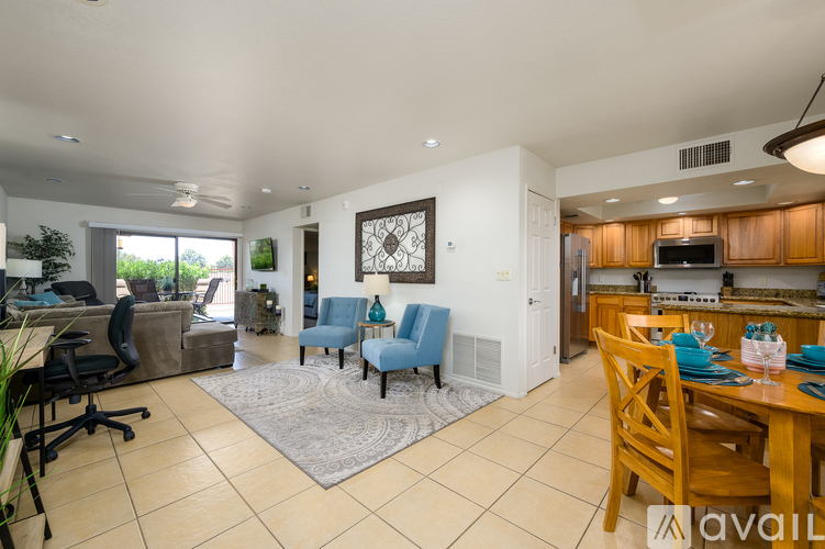 A spacious kitchen and dining area with a white ceiling and tiled floors.