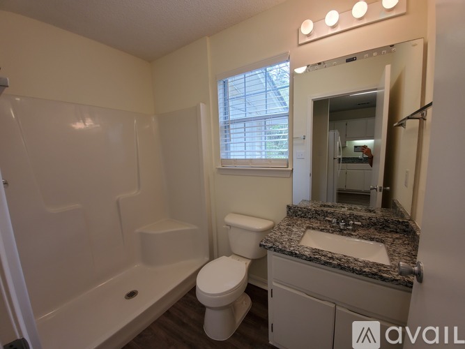 A bathroom with a toilet, sink, and bathtub.