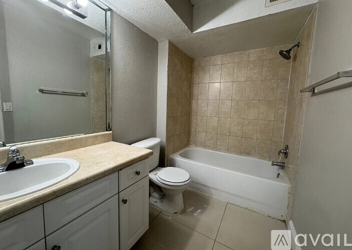 A bathroom with a toilet, sink, and bathtub.