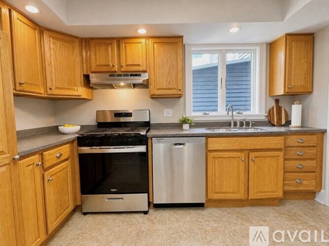 A kitchen with wooden cabinets and stainless steel appliances.