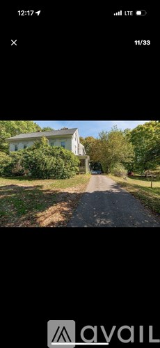 A house is situated on a tree-lined street.