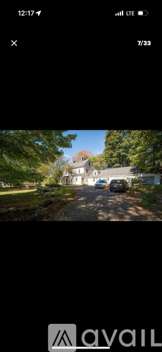 A car is parked on a driveway in front of a house.
