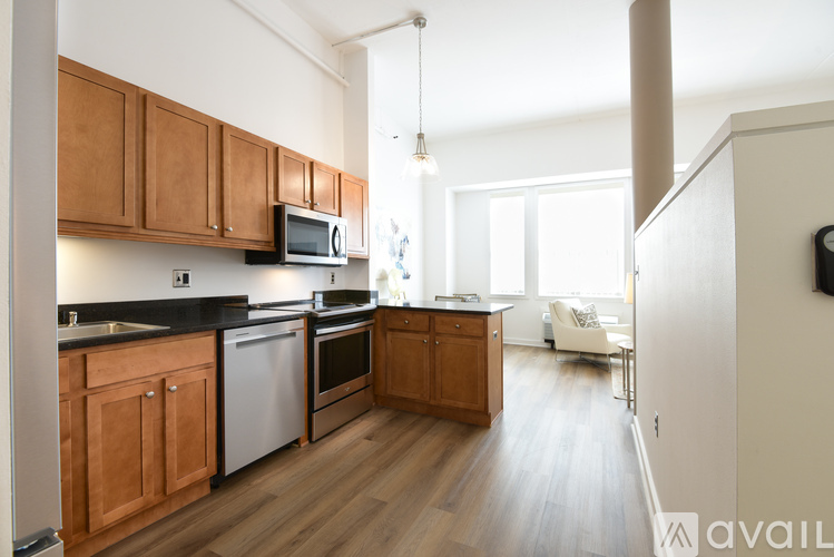 A kitchen with wooden cabinets and a black countertop.