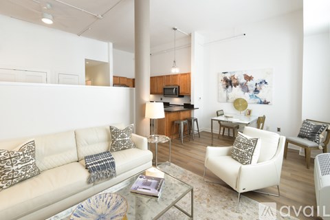 A living room with a white couch and a coffee table.