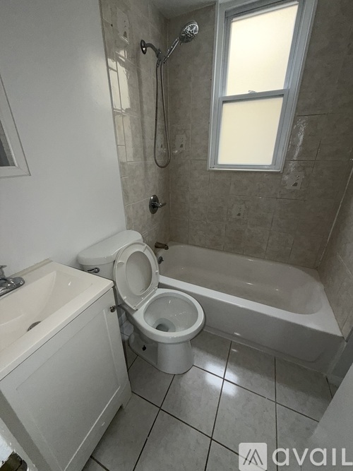 A bathroom with a toilet, sink, and bathtub.