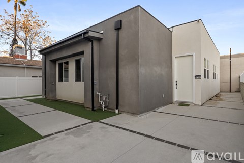 A modern house with a grey exterior is available for purchase.