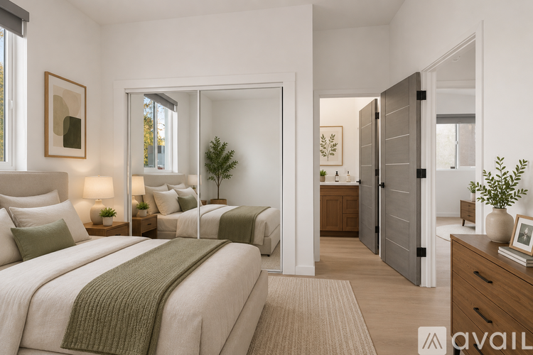 A bedroom with a large bed and a plant on the nightstand.