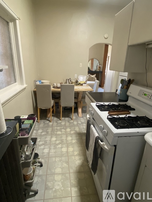 A kitchen with a table and chairs in front of a window.