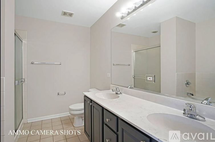 A bathroom with a toilet, sink, and mirror.