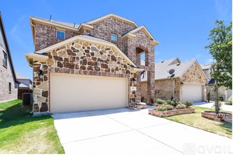 A large house with a stone facade and a white garage door.