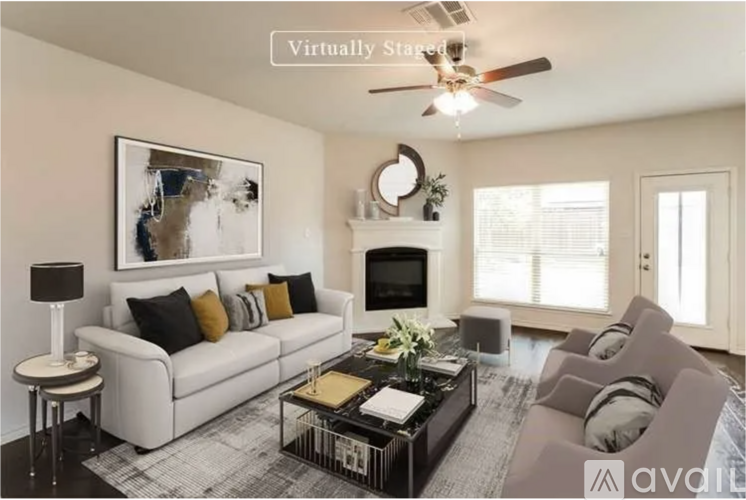 A living room with a white couch, a coffee table, and a painting on the wall.