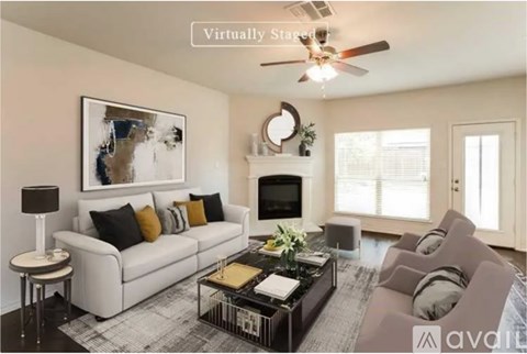 A living room with a white couch, a coffee table, and a painting on the wall.