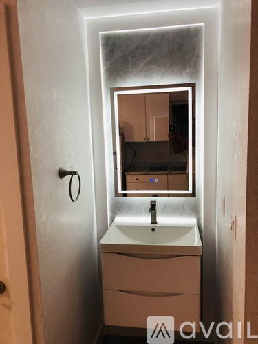 A bathroom with a sink and mirror.