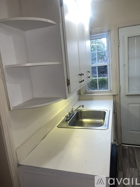 A kitchen with a sink and cabinets.