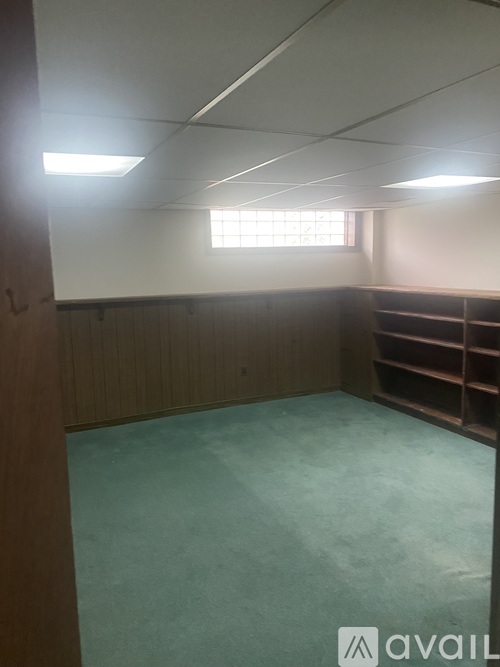 A room with wooden walls and a window.