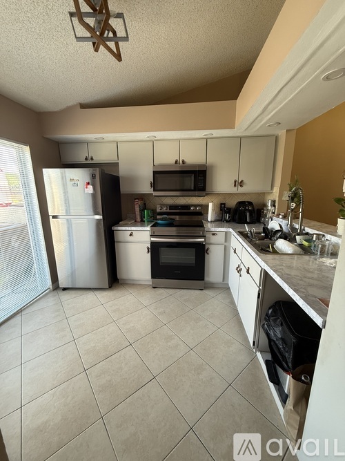 A kitchen with white appliances and a white refrigerator.