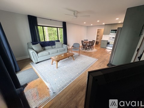 A living room with a grey sofa and a wooden coffee table.