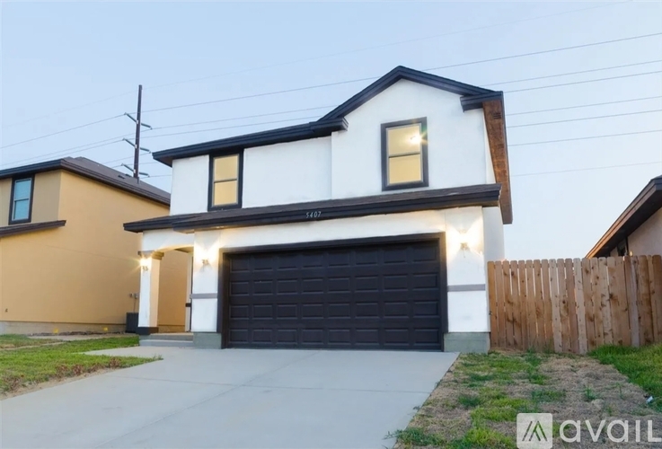 A two-story house with a garage is available for rent.