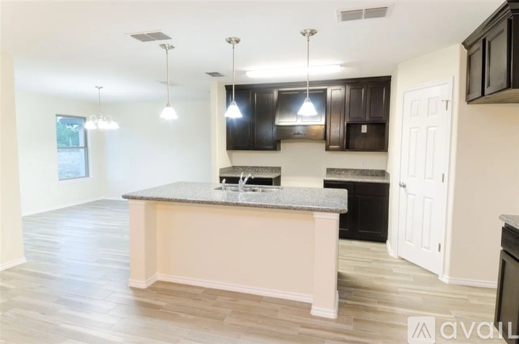 A kitchen with a large island in the middle.