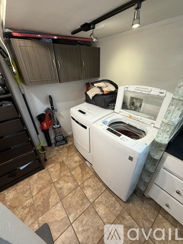A white washing machine and dryer in a small laundry room.